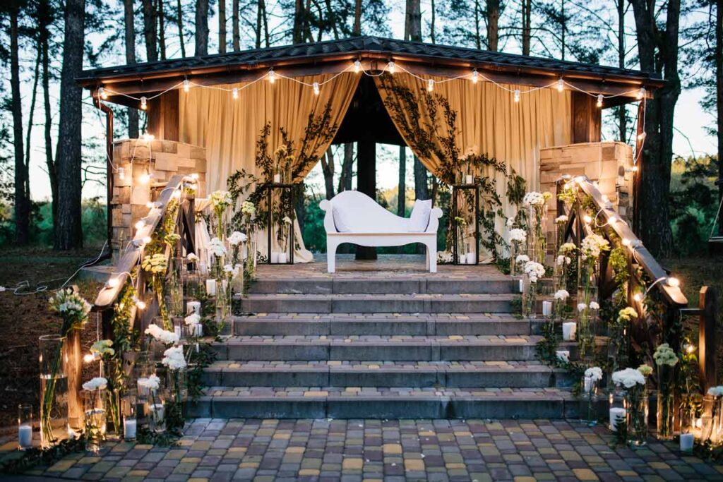 Gazebo decorated with string lights for wedding