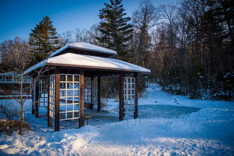 snow covered a hardtop gazebo